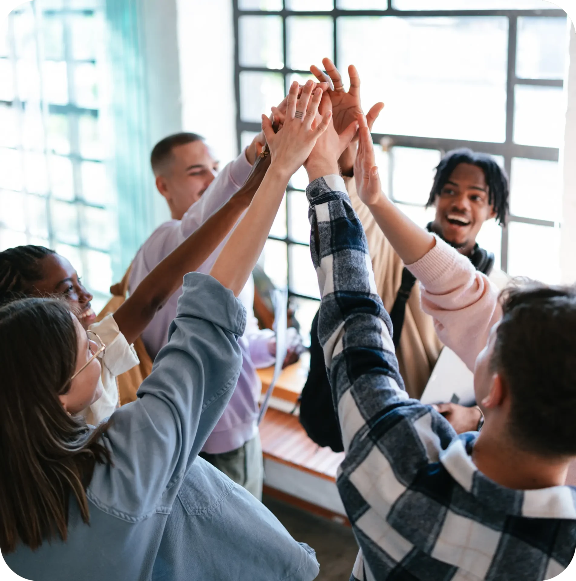 Group high-five celebrating teamwork