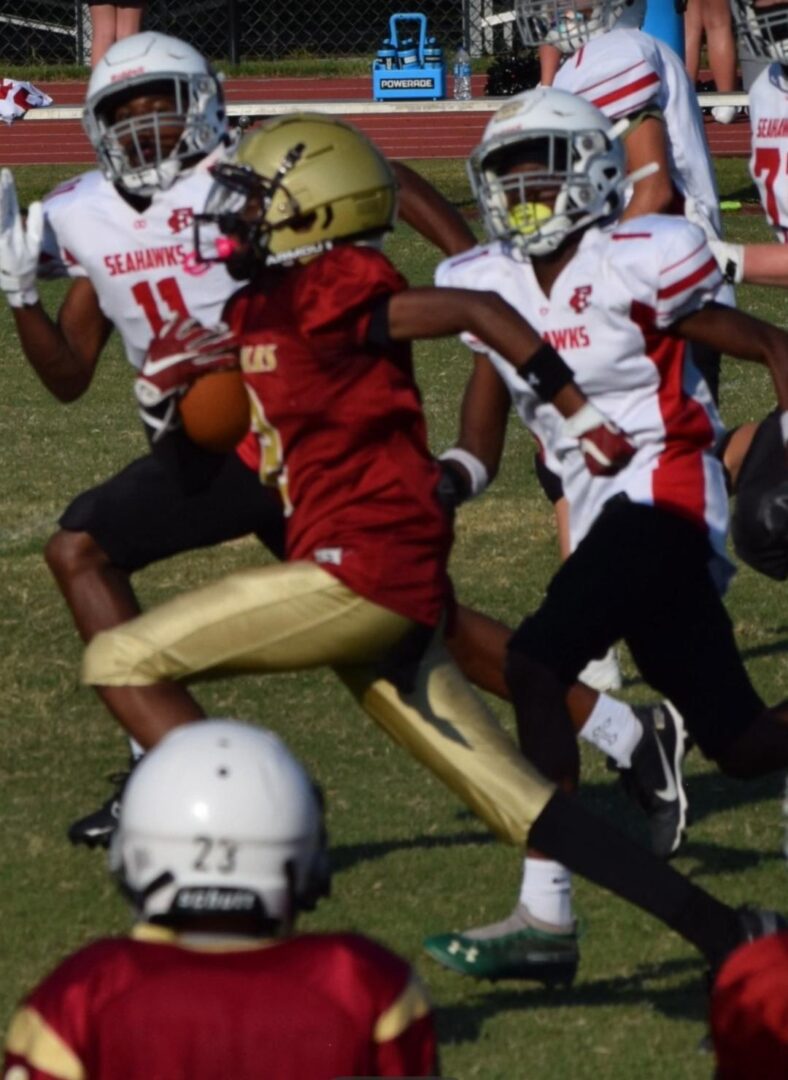 High school football players competing intensely on the field.